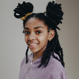 Little girl smiles after being relieved from eczema by Fate Skincare's products.