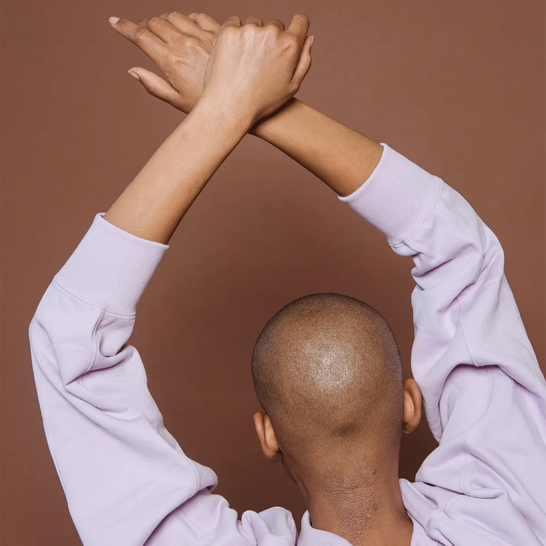 woman gets ready to use Fate Skincare's Himalayan Salt Scrub on her head before shaving.