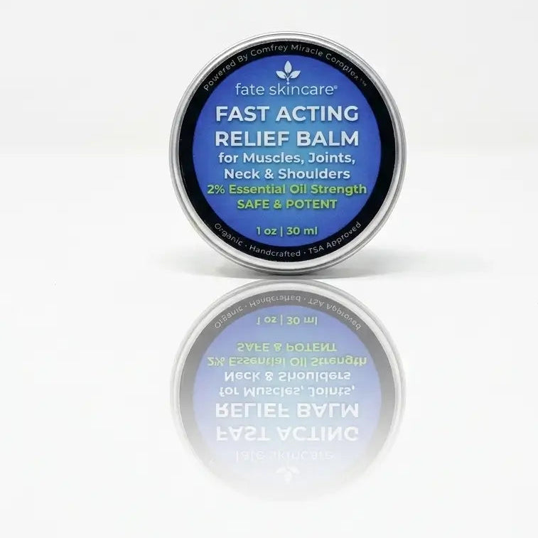A 1 oz TSA-approved tin of Fast Acting Relief Balm with a mirrored reflection, powered by Comfrey Miracle Complex for muscle and joint support