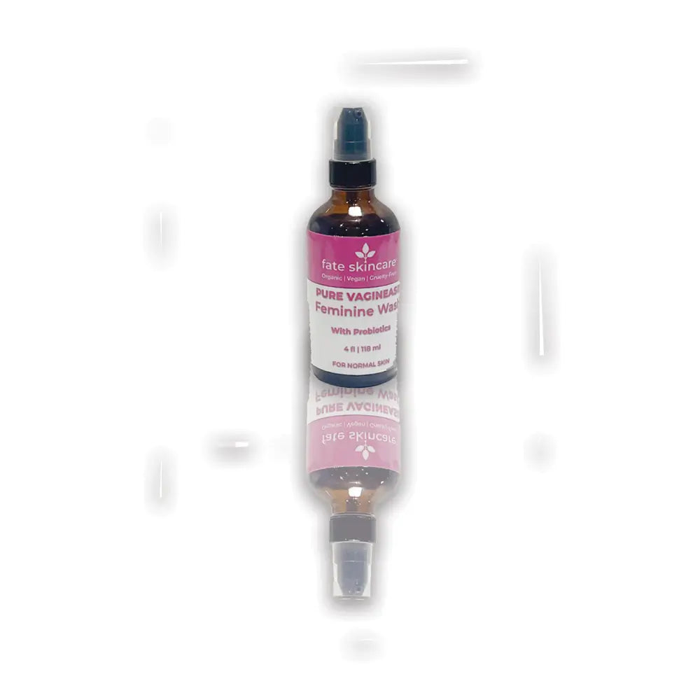 Pure Vaginease™ Feminine Wash by Fate Skincare in an amber spray bottle with pink label, a 4 oz organic cleanser infused with probiotics for gentle daily care.