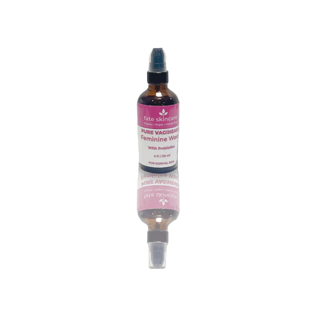 Pure Vaginease™ Feminine Wash by Fate Skincare in an amber spray bottle with pink label, a 4 oz organic cleanser infused with probiotics for gentle daily care.