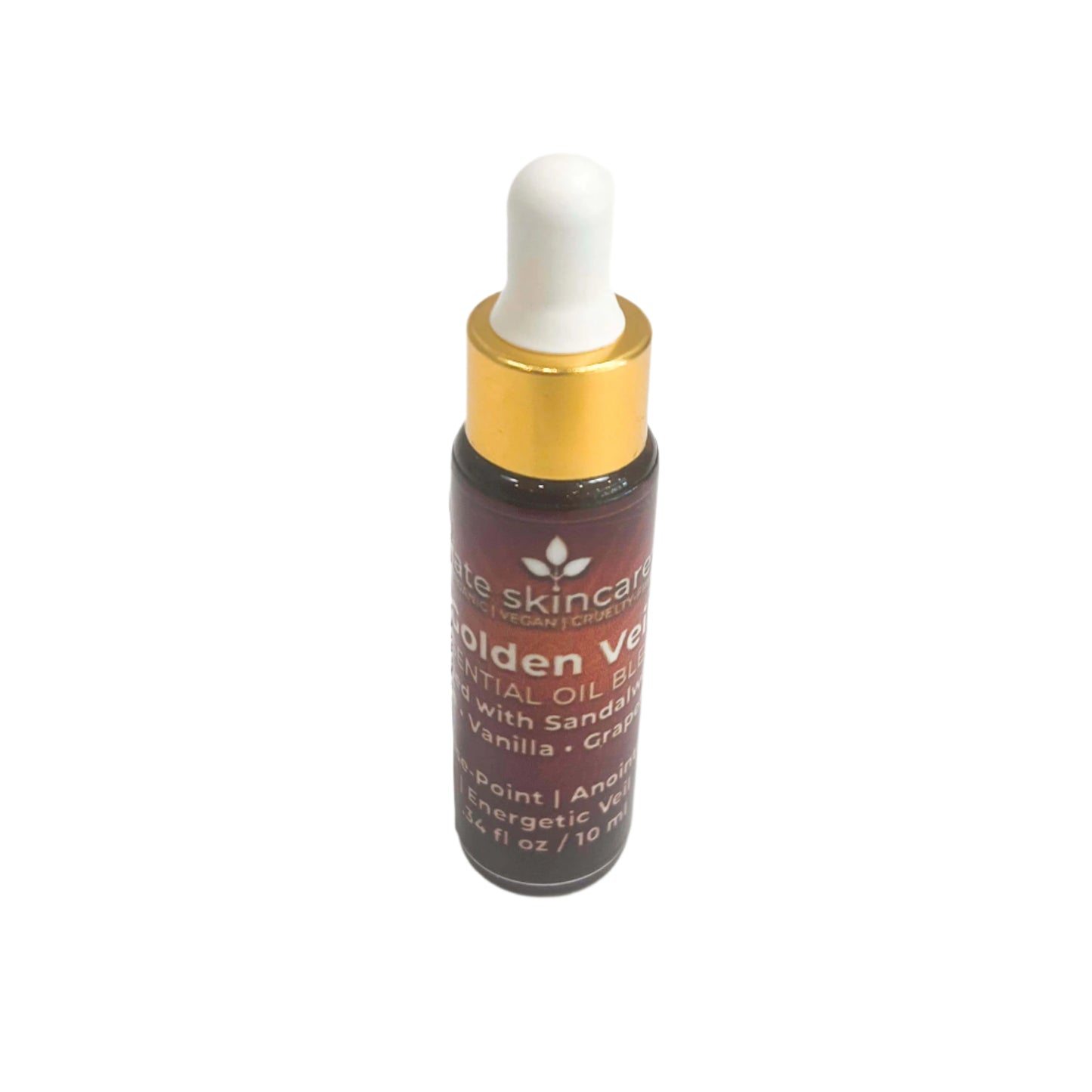 Fate Skincare Golden Veil Essential Oil Blend in a dark glass bottle with white dropper and gold collar, labeled with sandalwood, vanilla, and grape seed oil.