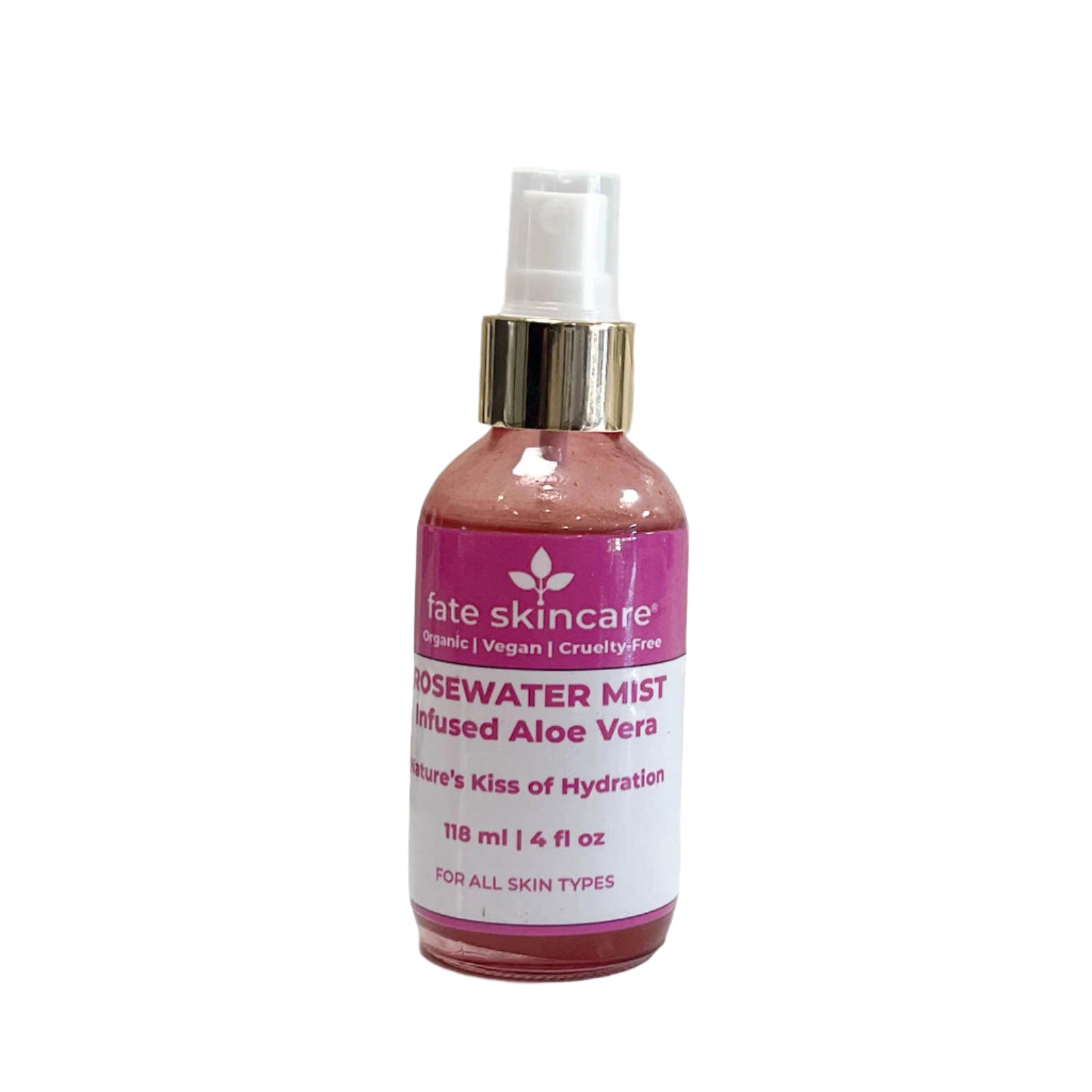 A pink glass spray bottle of "Fate Skincare Rosewater Mist Infused with Aloe Vera" with a gold-accented white spray nozzle, placed on a white surface with a textured white background. The label describes it as "Nature’s Kiss of Hydration" and states that it is suitable for all skin types.