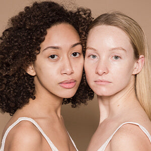 Mom and daughter pose for camera after using fate skincare products.