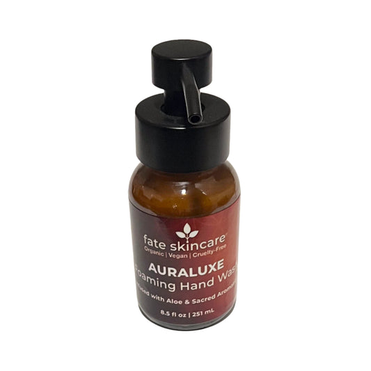 Centered front view of AuraLuxe™ Foaming Hand Wash in amber glass bottle with a rich burgundy label and bold white lettering. The pump is forward-facing, showcasing the premium packaging.