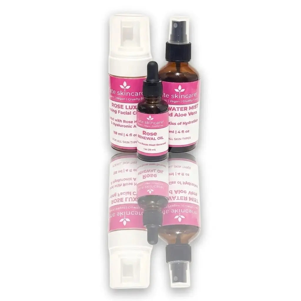 A 3-piece Fate Skincare Rose Radiance Ritual bundle featuring Rose Luxury Foaming Facial Cleanser, Rosewater Mist, and Rose Renewal Oil, displayed with a clean reflection on a white background.