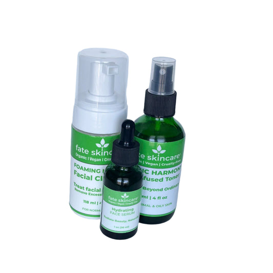 Fate Skincare's green-labeled 3-piece skincare collection, including a 1 oz Hydrating Face Serum with dropper, a 4 oz Foaming Gel Facial Cleanser, and a 4 oz Botanic Harmony Toner in green glass bottles, designed for normal and oily skin types.


