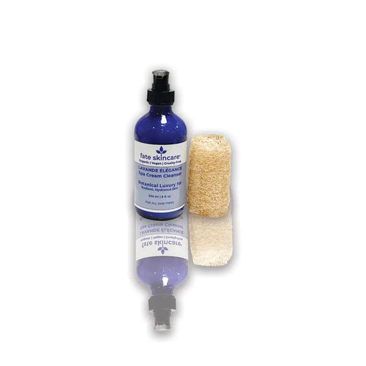 Lavande Élégance Spa Cream Cleanser by Fate Skincare in a cobalt blue pump bottle with natural loofah, crafted for radiant, hydrated skin with botanical luxury.
